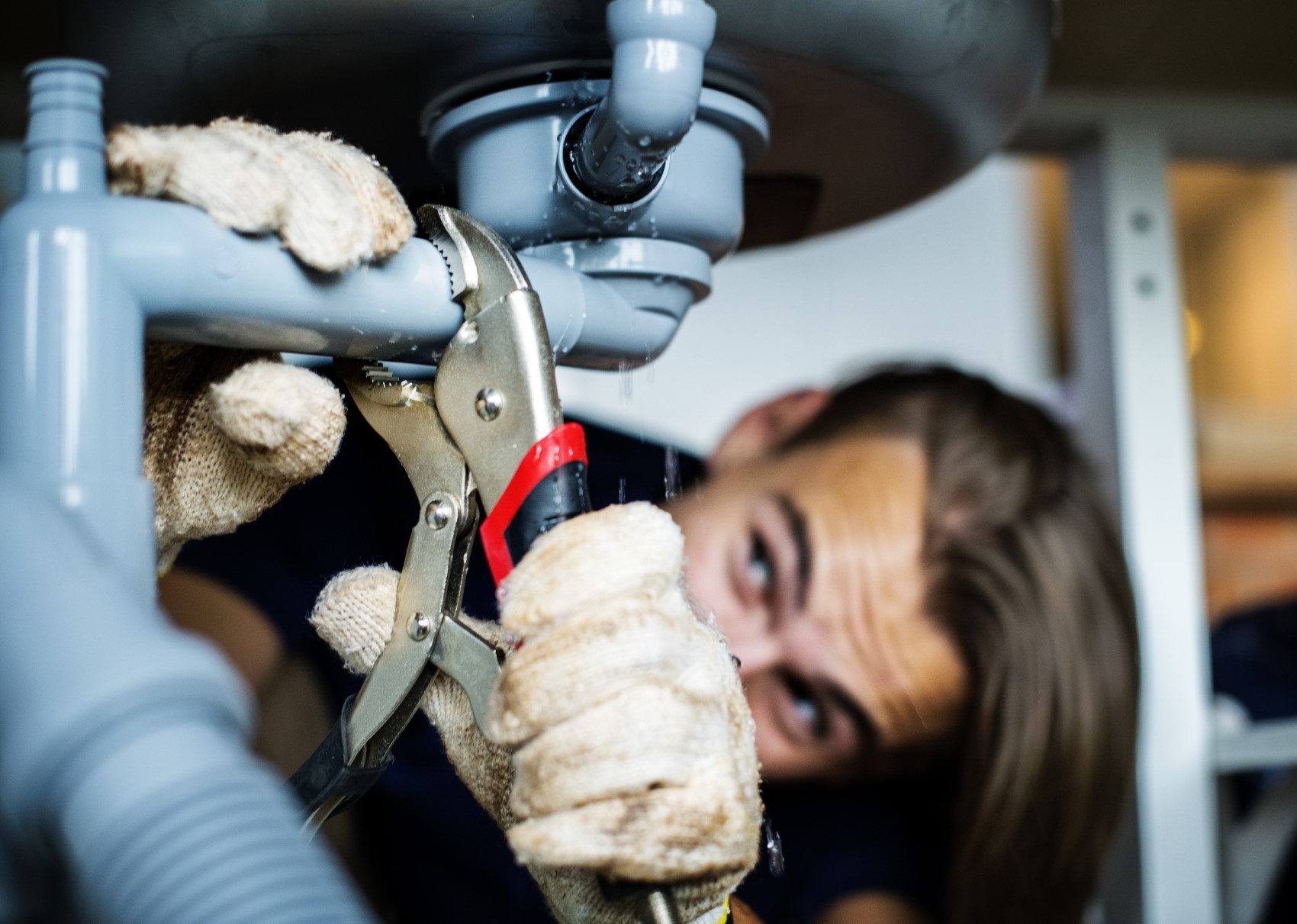 Man fixing leaky pipe in greenville or spartanburg