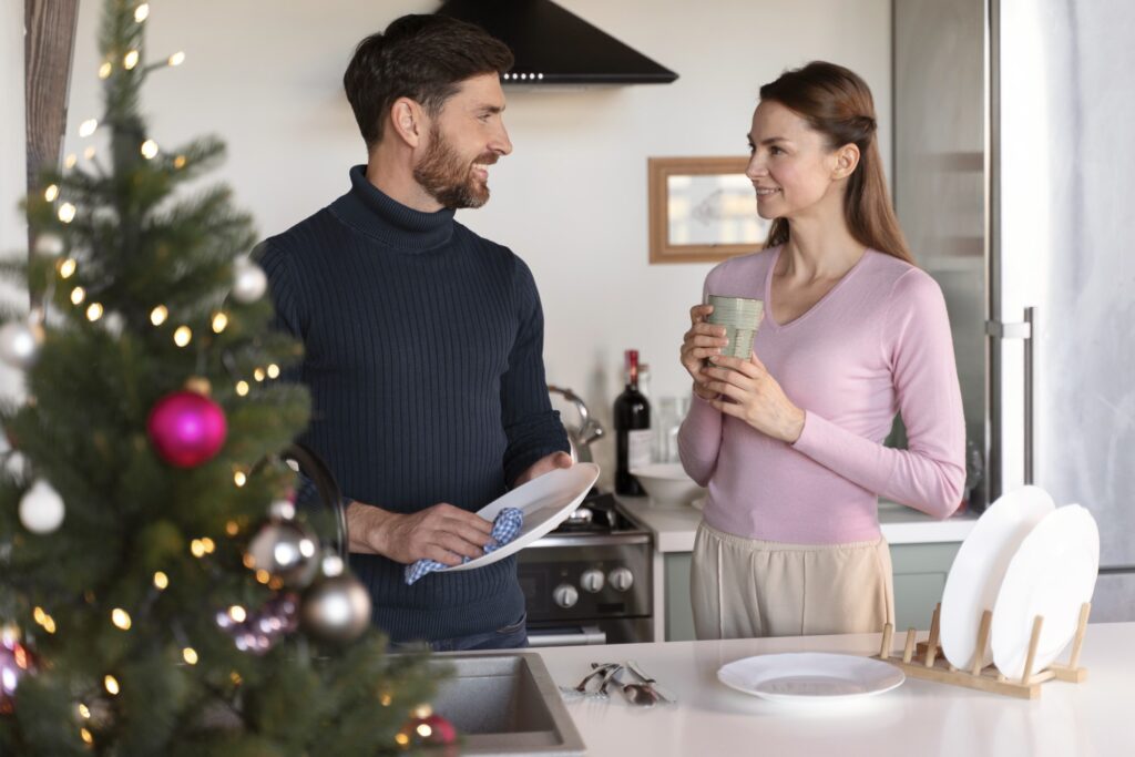 couple doing the dishes following these Greenville Affordable Plumber Tips for the Holidays